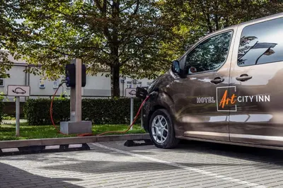 a van is being hooked up to a electric car at Art City Inn in Vilnius