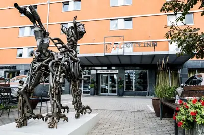 a statue of two people standing in front of a building at Art City Inn in Vilnius