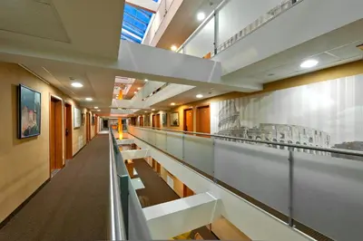 a long corridor in a building with tables and chairs at Art City Inn in Vilnius