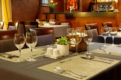 a table in a restaurant with wine glasses on it at Art City Inn in Vilnius