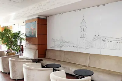 a waiting room with a couch and chairs at Art City Inn in Vilnius