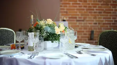 a table with a white table cloth and a vase of flowers at BEST WESTERN Santakos Hotel in Kaunas