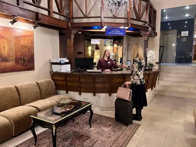 a woman standing at a counter in a store at BEST WESTERN Santakos Hotel in Kaunas