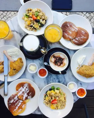 a table full of plates of food with different foods at Vilnius Grand Resort in Ežeraičiai