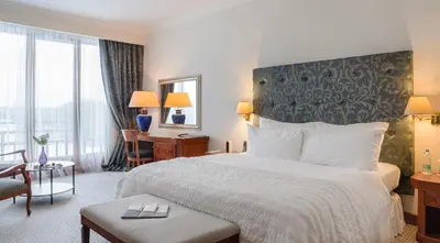 a hotel room with a bed and a desk at Vilnius Grand Resort in Ežeraičiai