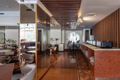 a restaurant with a bar and tables and chairs at Best Western Vilnius in Vilnius