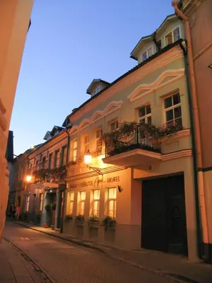 a building on the side of a street at night at Hotel Apia in Vilnius