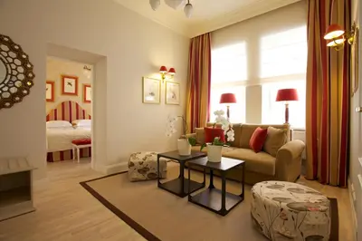 a living room with a couch and a table at Hotel Apia in Vilnius
