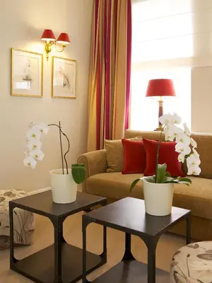 a living room with two tables and a couch at Hotel Apia in Vilnius