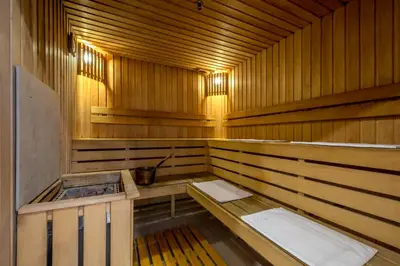 a wooden sauna with two sinks in it at Ratonda Centrum Hotels in Vilnius