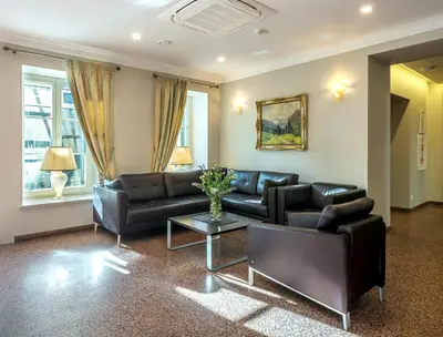 a living room with a couch and a table at Ratonda Centrum Hotels in Vilnius
