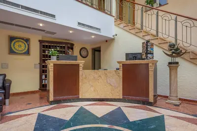 a lobby with a reception desk in a building at Artis Centrum Hotels in Vilnius