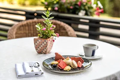 a plate of food on a table with a cup of coffee at VILNIUS PARK PLAZA HOTEL & SPA, Restaurant, Panorama Bar, Conference & Banquet Center in Vilnius