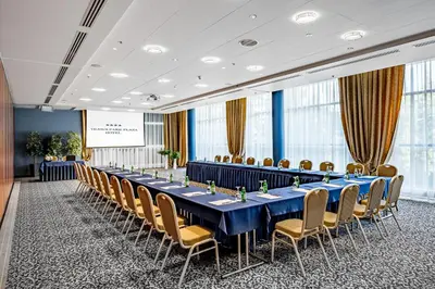 a conference room with a long table and chairs at VILNIUS PARK PLAZA HOTEL & SPA, Restaurant, Panorama Bar, Conference & Banquet Center in Vilnius