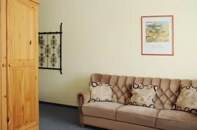 a living room with a couch and a picture on the wall at Amicus Hotel in Vilnius