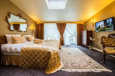 a hotel room with a bed and a mirror at Imperial Hotel & Restaurant in Vilnius