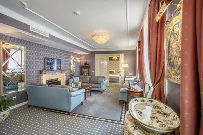 a living room with a blue couch and chairs at Imperial Hotel & Restaurant in Vilnius