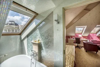 a bathroom with a window and a tub in a room at Imperial Hotel & Restaurant in Vilnius