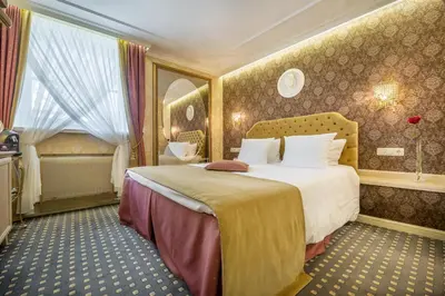 a bedroom with a large bed in a room at Imperial Hotel & Restaurant in Vilnius