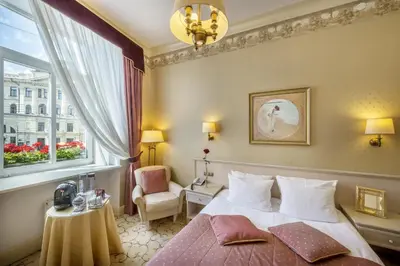 a hotel room with a bed and a window at Imperial Hotel & Restaurant in Vilnius