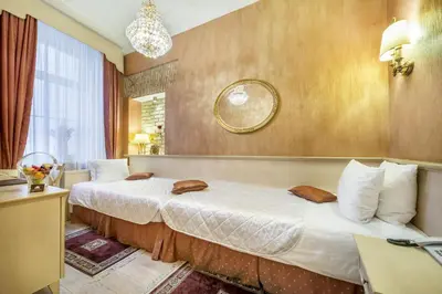a hotel room with two beds and a window at Imperial Hotel & Restaurant in Vilnius