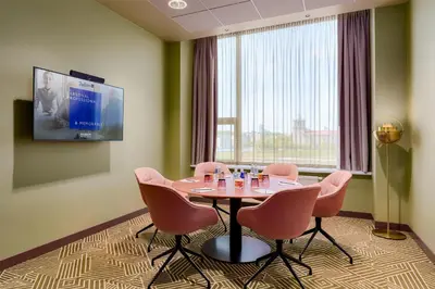 a conference room with a table and chairs and a tv at Radisson Blu Hotel Lietuva in Vilnius