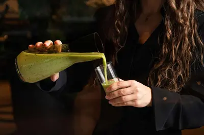a woman pouring a drink into a glass at Radisson Blu Hotel Lietuva in Vilnius