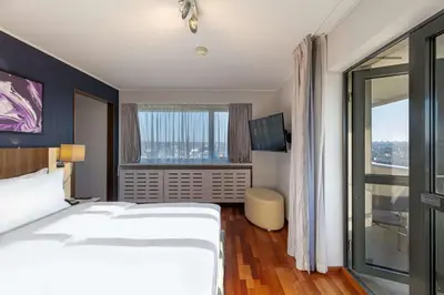 a hotel room with a bed and a large window at Radisson Blu Hotel Lietuva in Vilnius