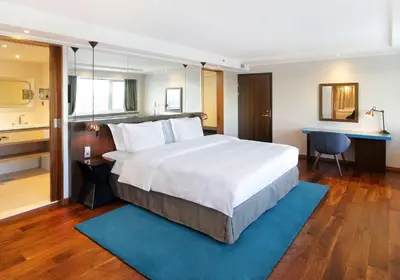 a large bedroom with a large bed and a desk at Radisson Blu Hotel Lietuva in Vilnius