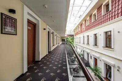 an empty corridor in a hospital building with a ceiling at Amberton Cathedral Square Hotel Vilnius in Vilnius