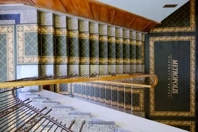 an empty staircase in a building with books at Hotel Metropolis in Kaunas