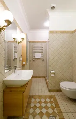 a bathroom with a sink and a toilet at Hotel Metropolis in Kaunas