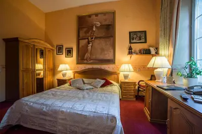 a bedroom with a bed and a desk with two lamps at Shakespeare Boutique Hotel in Vilnius
