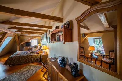 a bedroom with a bed and a mirror in a room at Shakespeare Boutique Hotel in Vilnius