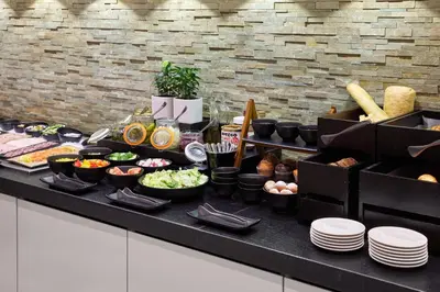 a buffet with many different types of food on a table at Holiday Inn Vilnius by IHG in Vilnius