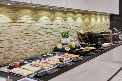 a buffet with many different types of food on a counter at Holiday Inn Vilnius by IHG in Vilnius