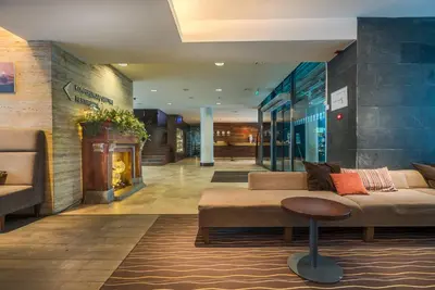 a lobby with a couch and a table in a building at Hotel Panorama in Vilnius