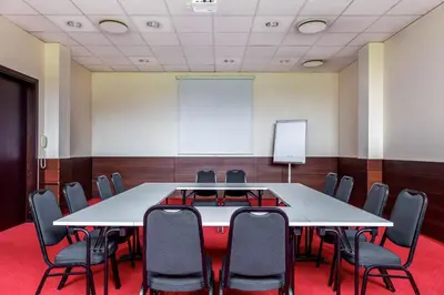 a conference room with a white table and chairs at Hotel Panorama in Vilnius