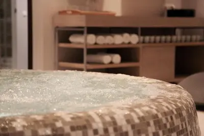 a close up of a table with a shelf of towels at City Hotels Rūdninkai in Vilnius
