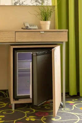 a computer monitor under a desk with a computer screen at City Hotels Rūdninkai in Vilnius