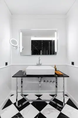 a white bathroom with a sink and a mirror at Grotthuss Boutique Hotel Vilnius in Vilnius