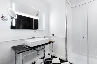 a bathroom with a sink and a shower at Grotthuss Boutique Hotel Vilnius in Vilnius