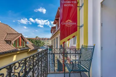 a balcony with a sign on a hotel at Grotthuss Boutique Hotel Vilnius in Vilnius