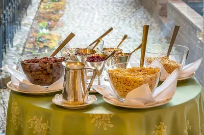 a table topped with bowls of nuts and other food at Grotthuss Boutique Hotel Vilnius in Vilnius