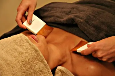 a man laying in a towel holding a wii remote at Grotthuss Boutique Hotel Vilnius in Vilnius