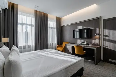 a hotel room with a bed and a desk at Congress Hotel in Vilnius
