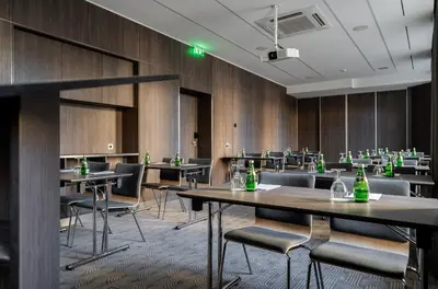 a conference room with tables and chairs with bottles on them at Congress Hotel in Vilnius