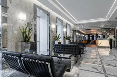 a row of black benches in a lobby at Congress Hotel in Vilnius