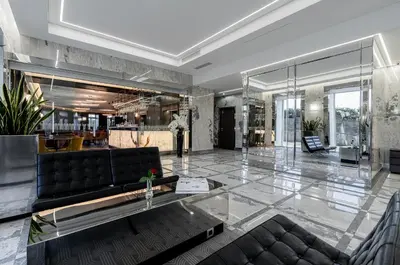a living room with a couch and a table at Congress Hotel in Vilnius