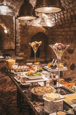 a long table with plates of food and wine glasses at NARUTIS Hotel - Small Luxury Hotels of The World in Vilnius